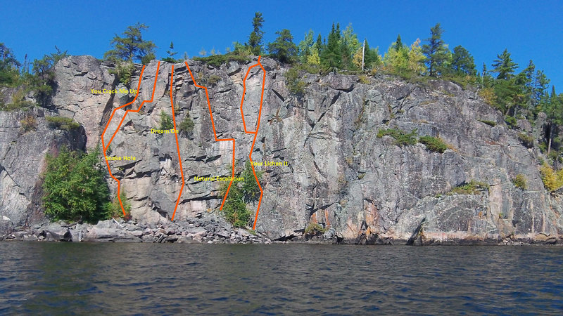 A front look at the cliff face with established routes marked