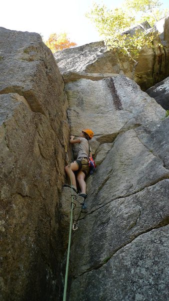 Preparing to clip the pin before the first ledge on the first pitch.