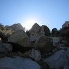 On our hike out (back down to Aguirre Springs), looking up the approach Gulley.  LtoR:  Middle Rabbit Ear (w/ the church key looming over the MRE/NRE col), North Rabbit Ear, The Cwm, and Last Peak.  As can be seen in the photo, there is some boulder scrambling to get up the approach gulley.  One of several micro-pine forests is partially obscuring The Cwm.