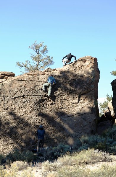 Various boulderers, enjoying the various warm ups on the Crippler Boulder.