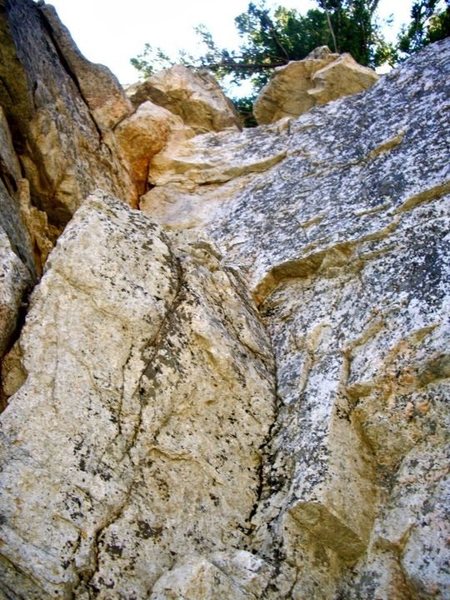 A look up the route, with the crack on the left. I apologize, this image sucks, but it's all I have at the moment as I was busy cleaning the biggest loose blocks off the route that day.