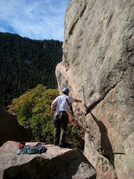 Clipping the 1st bolt on Rightist before stepping across and starting the climb.  