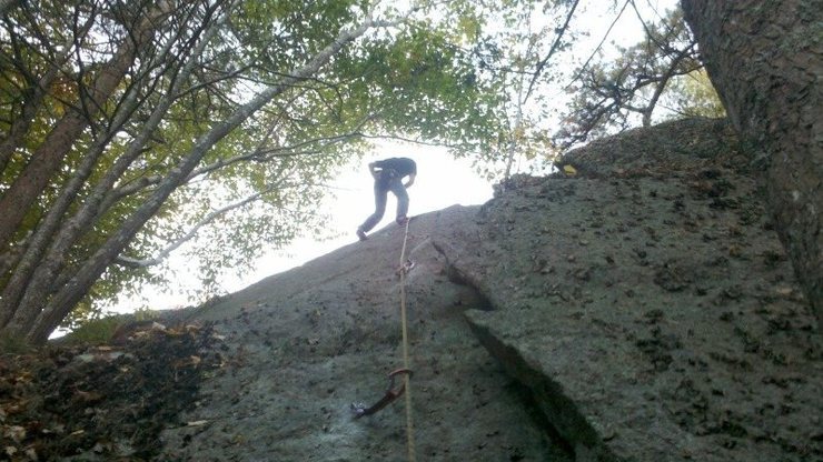 Butt shot from the belay of Roll the Bones. This shows the route starting on the right side flake, then transitioning out onto the face.