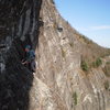 Mary making the traverse to the comfy ledge on the Traditions linkup below the 10a pitch.