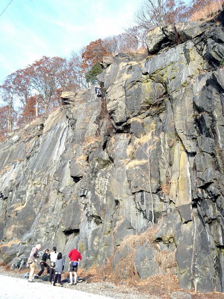 A climber near the top of Crips & Bloods. Bat Crack is on his left, and Tradocity is on his right.