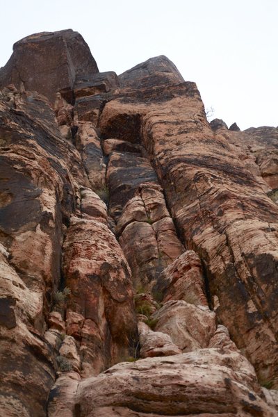 Route starts bottom right in photo, go up crack and left under roof.  Then go slight left up to another roof, pull it then climb the large inside corner to a ledge.