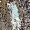 Climber on a lower formation (yellow jacket, upper left). Steep hike down from road on Dec 23, 2011.