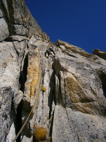 Climbing the extensive corner / chimney system in the lower half of the Perrenoud route