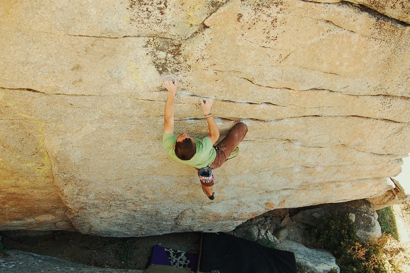 Vlad's Crimps V3, a slight overhang w/ great holds and a bad landing/take pads.. Just downhill and left (south) of the routes.