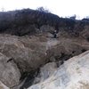 Steep rock under overhangs:  climbing in the rain at Landro