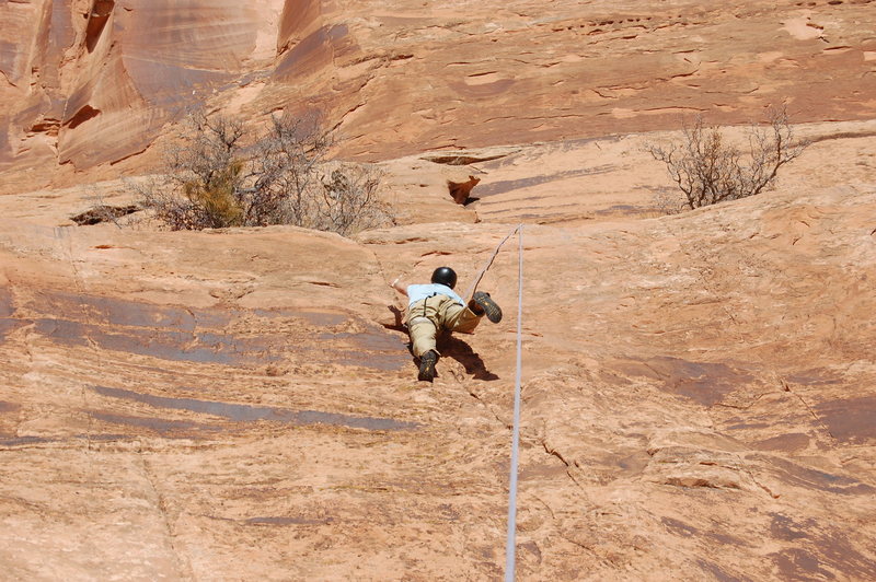 My Climbing Partner on The school house slab making a move up the middle route