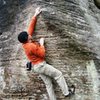 Mike reaching high to the small crimp at the base of the arete.