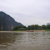 The impressive wall to the left and the small village of Pak Ou from the waters of the Mekong on a slowboat ride.