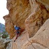 Traveling with Charlie around the super exposed prow. A good nut placement keeps you from pendulum-ing back into the wall below your belayer.