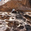 Lead climbing at Hueco Tanks to the utter amazement of the college boulderers. 