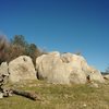 A three boulder cluster with various widths of cracks to play on, as seen from the trail from Beeks Bight.