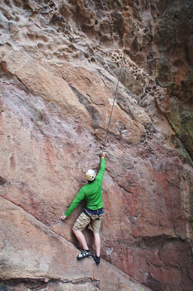 Climber on Triceratops Tracks (5.10) on Dinosaur Rock.