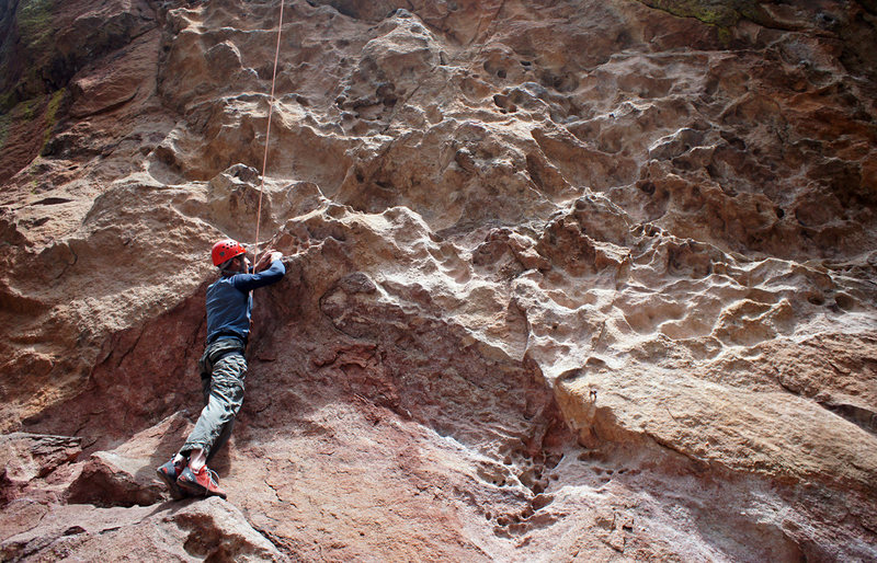 Climber at the start of Tracks are for Kids on Dinosaur Rock.