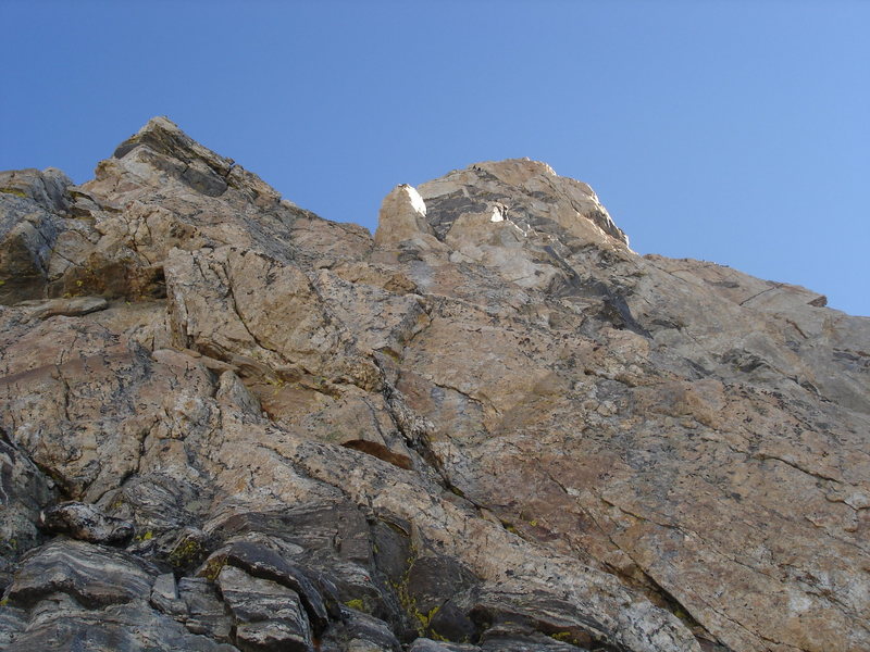 The route above P2.  Slabs, V-slot pitch, Black Face, climbers above the Black Face on the off-balance hand crack pitch.