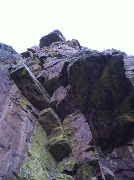 Further 5.10d<br>
<br>
Starts at a bolt under the lower larger roof.  Traverse to the visible piton and head straight up.  Follow the arete and stay just slightly right of the huge roof.  Anchors are on the ledge just above the roof.