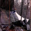 March 1989. Ben taking a rest while aid cleaning Molson's Madness. This photo gives a good idea of how far off the ground the route gets. It starts above the slab on the R and quickly angles up.