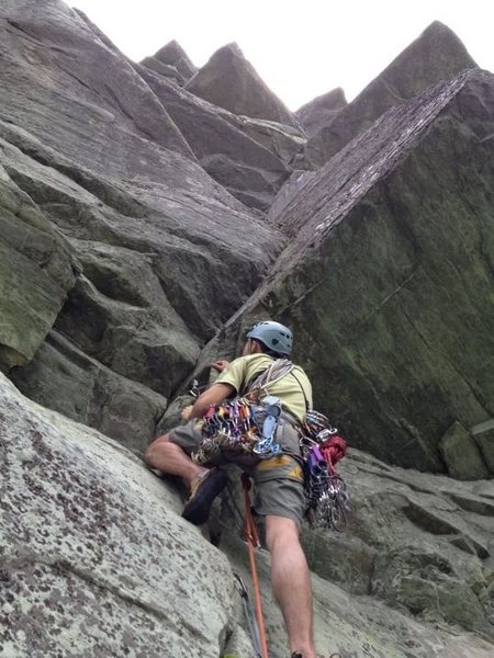 Balti Porter follows straight up through the corner all the way up. After reaching a boulder pile near the top you can reconnect with P3 of Hindu Kush and finish.<br>
<br>
If there is a 5.10 move, it's probably pulling through that first roof but an easier better protected path dodges slightly left and jogs back right over the roof.