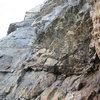 The alcove belay. From here we climbed four pitches to the top of the buttress. The first of these traversed around the left side of this small roof to a hand crack. 