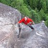 Derek Pearson at the top of A Ship Called Black Rock (5.10c/d). <br>
<br>
The white horn of rock in the distance (below & right of climbers left foot) is the anchors at the top of p1 of Law and Order.