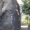 Northwest Corner.  Slap left hand up the arete for the first few moves before moving to crimps on face.  Easy top-out!