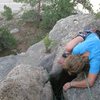 Original Route - She's looking for something, but this is the top of the route at the belay tree (behind camera).  The route goes down and to the right on the rock.