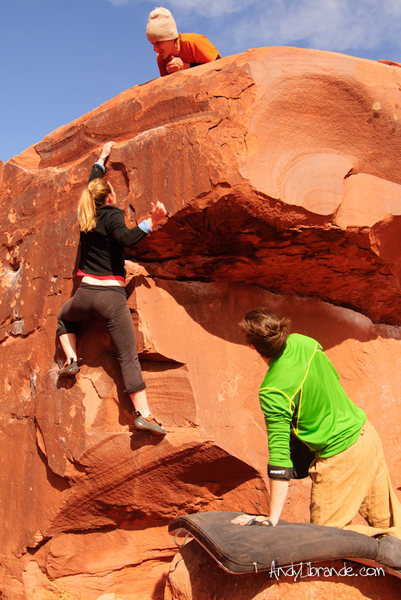 Caitlin moving to the upper rail which is the last good hold before the top-out. Rambo is up top enjoying the show. 