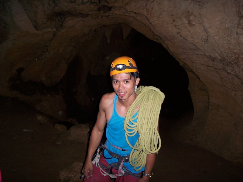 Raymond bringing the rope to the climbers rappel before exploring the cave