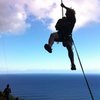 Travis rappelling off a route at the Mokuleia Wall, Hawaii