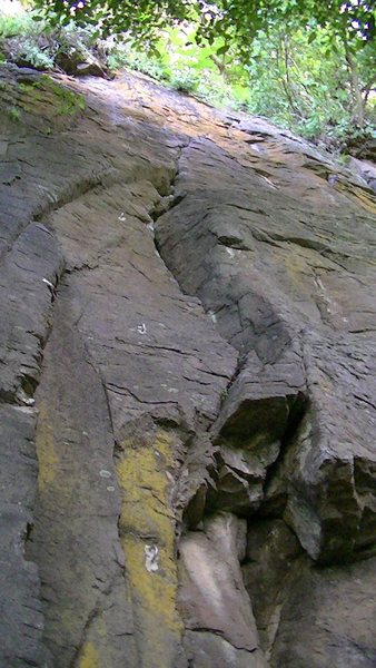 The route starts in the yellow patch and slants upward to the right where the anchors are in another yellow spot of the rock.