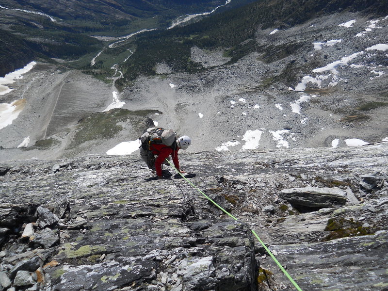 WEST FACE DOWN-CLIMB<br>
After two rappels, almost down some 5.0 to a nice ledge that leads 50 meters back to the NW Ridge; rejoining just a few meters above the highest bolts.