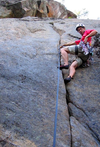 Climber getting pro before launching into the crux