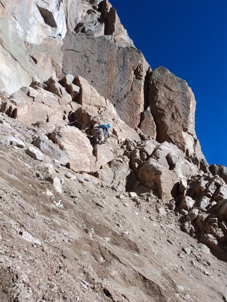 Joe starting P1 of the route (left start) after crossing scree on hard snow.  Do not go too high here.  You aim for below the lowest notch on the skyline.