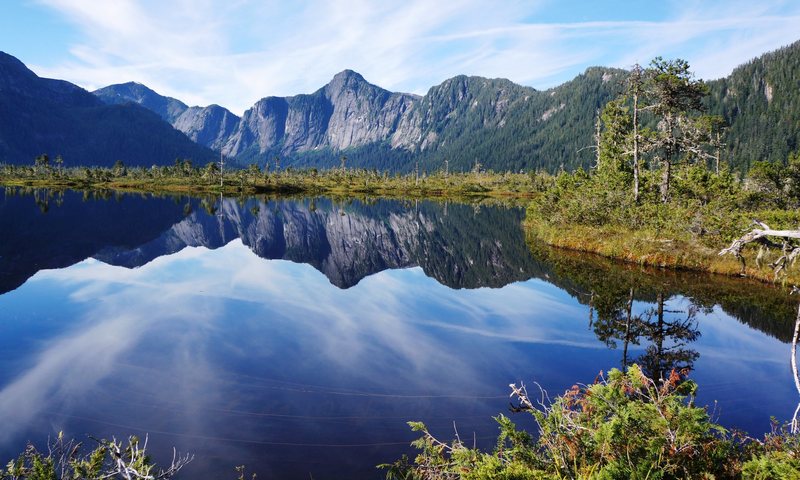 a lake on an island on a lake in the wilderness, with unclimbed granite domes in all directions at sunrise