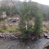 Looking back to the road, showing the tyrolean traverse over to the pod.  As of Sept. 2012, there are two lines, one with the sheath totally worn off.  The tree climb is a breeze with a rope to clip into for safety along the way.  Enjoy!