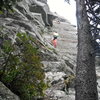 Jonathan approaches the cruxy roof on Boardwalk, 5.8.