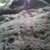 A climber working through the overhang, not yet to the crux.