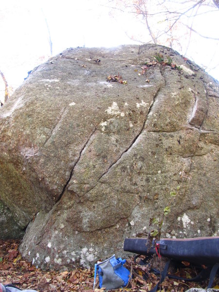 Battle of the bulge... Sit start at low jug to the far left of photo. The furthest left dark crack is used, and the chalk way left for compression. Surmount the bulge and slab up to the top.