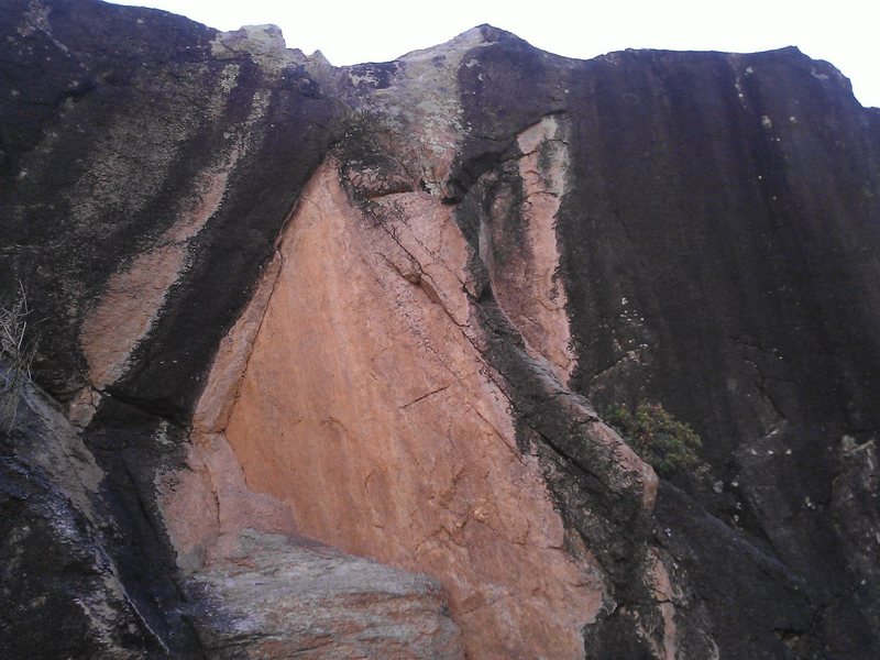 Straight-on shot of V2 (?) Started bottom right on the black flake , followed the arete to the left side-pull, topped out on the half white/half black jug. Great climb, but watch out for choss at the top. <br>
