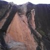 Straight-on shot of V2 (?) Started bottom right on the black flake , followed the arete to the left side-pull, topped out on the half white/half black jug. Great climb, but watch out for choss at the top. <br>
