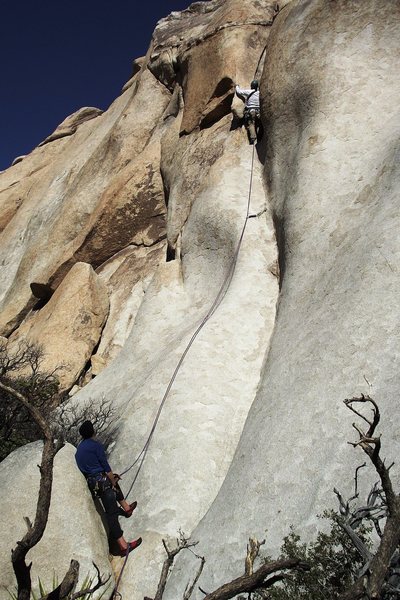 Parental Guidance.  The soft crux is just beyond the cam stuffed in a pocket.  A mellow, aesthetic route in a fine place. We descended to the left from the top.  Photo: Dave Rockwell, belayer, Todd Bradley, climber John Ely. 2012