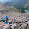 Greg making the last choss mantle moves to the top of Dallas Peak.