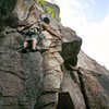 Luan Kruger of S Africa contempeting the 5.9 + crux on Diedra, Cathedral Ledges, NH