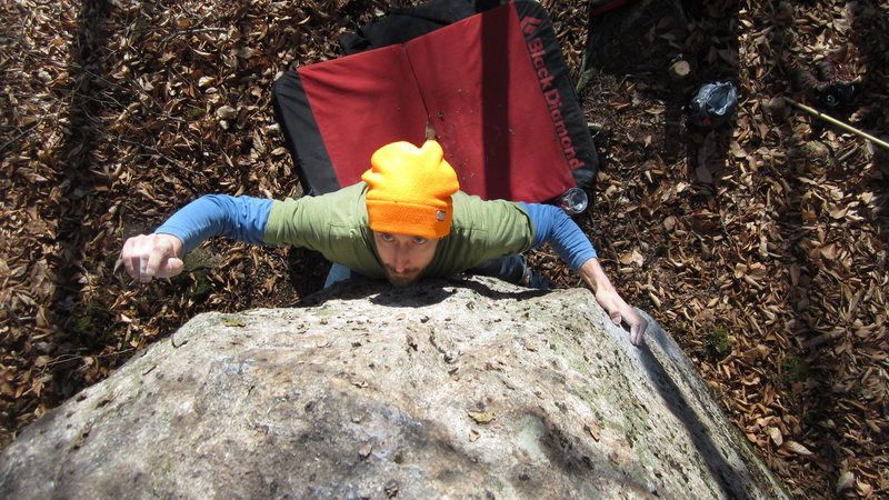 Jay Knower making the crux reach on the Tomahawk.