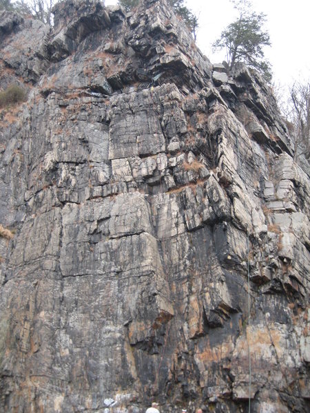 The climb starts on the right side of the picture next to the green rope.  It continues up the rope till after the small overhang.  Then go right.