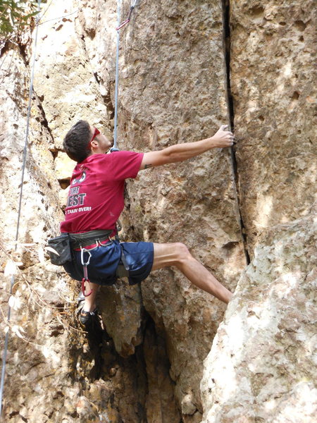 A climber working up the crack at the start of "Wonder Woman." Come on Dude just jam your digits into that crack.